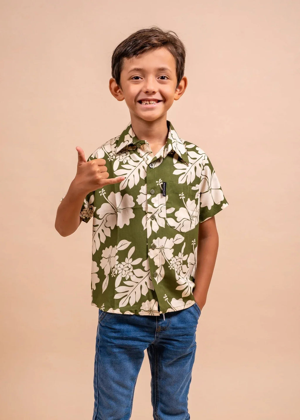 Boy wearing a olive polynesian shirt with Flower pattern