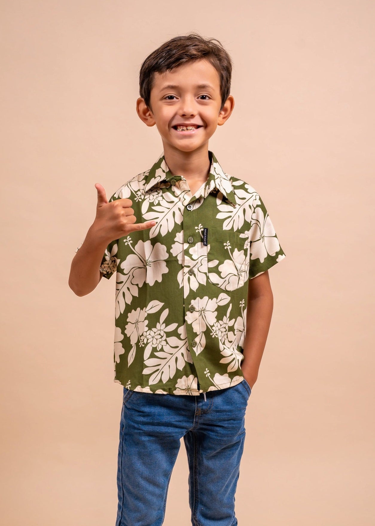 Boy wearing a olive polynesian shirt with Flower pattern  