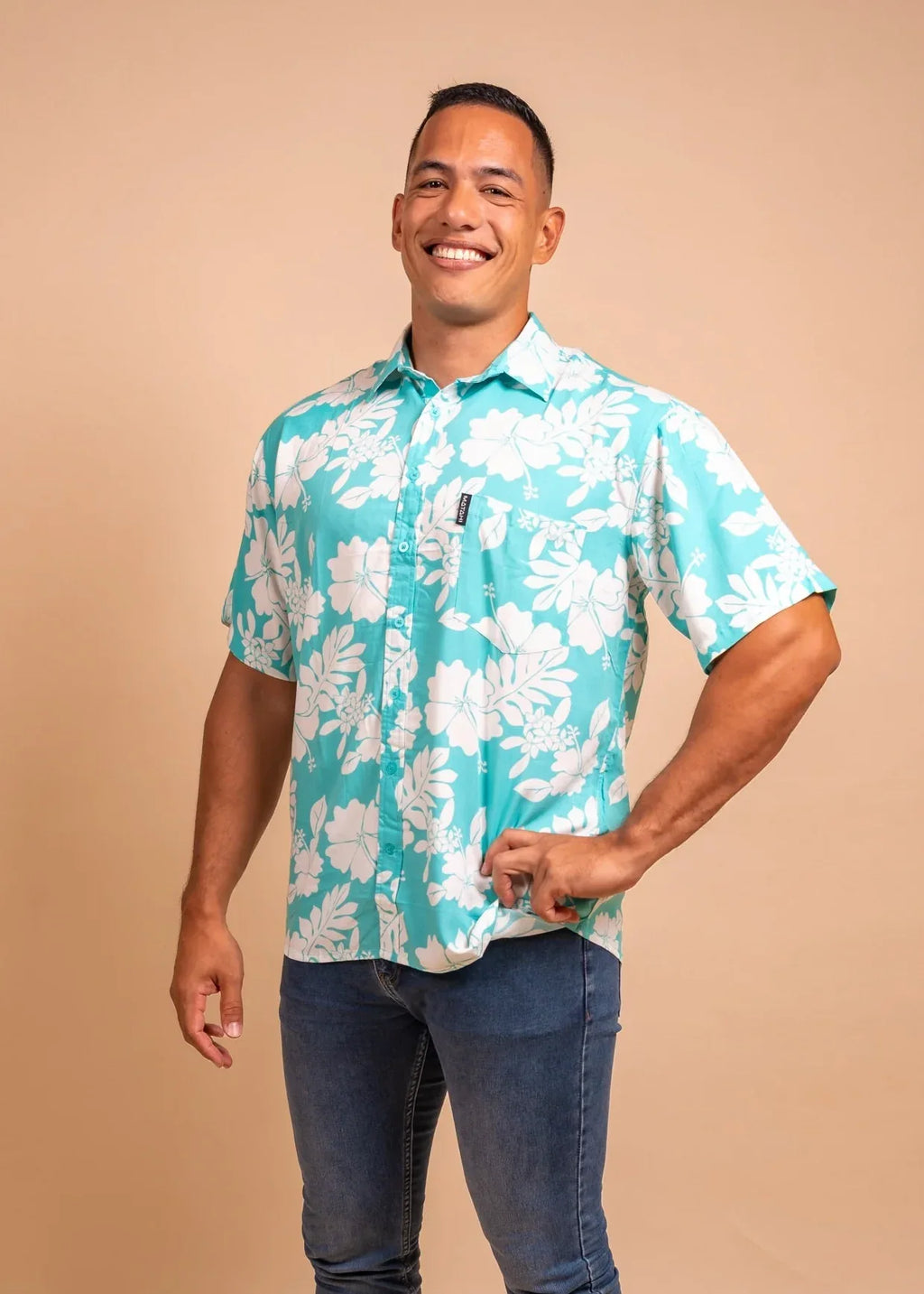 Man wearing a light bleu polynesian shirt with flower pattern