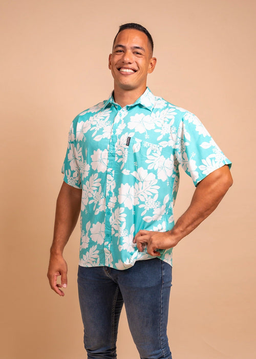 Man wearing a light bleu polynesian shirt with flower pattern 