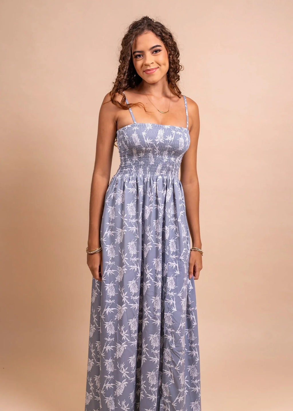 Women wearing a cute polynesian dress in grey color with pinaeple pattern