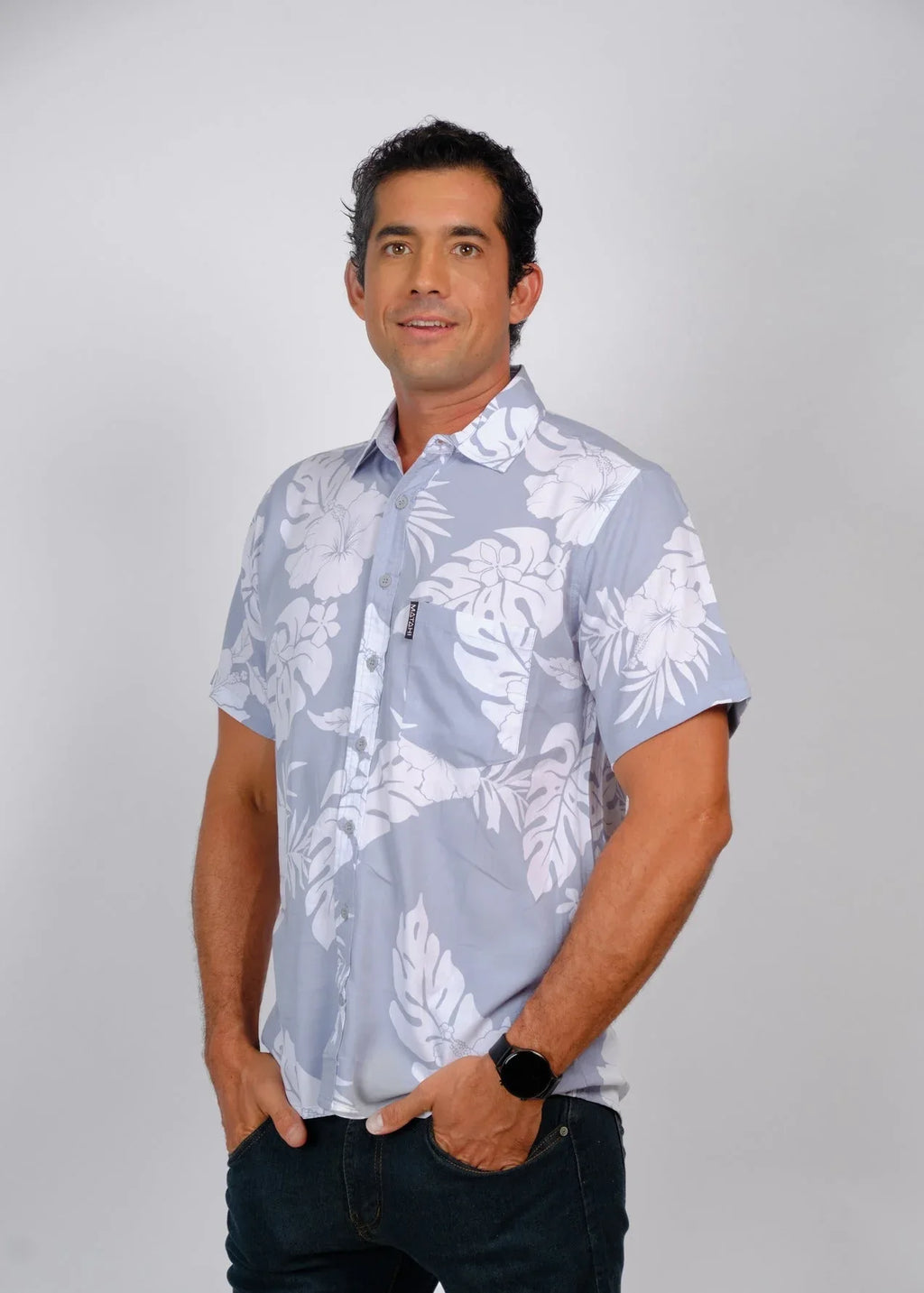 Tahitian man wearing a grey Polynesian floral Bamboo Kultur shirt.