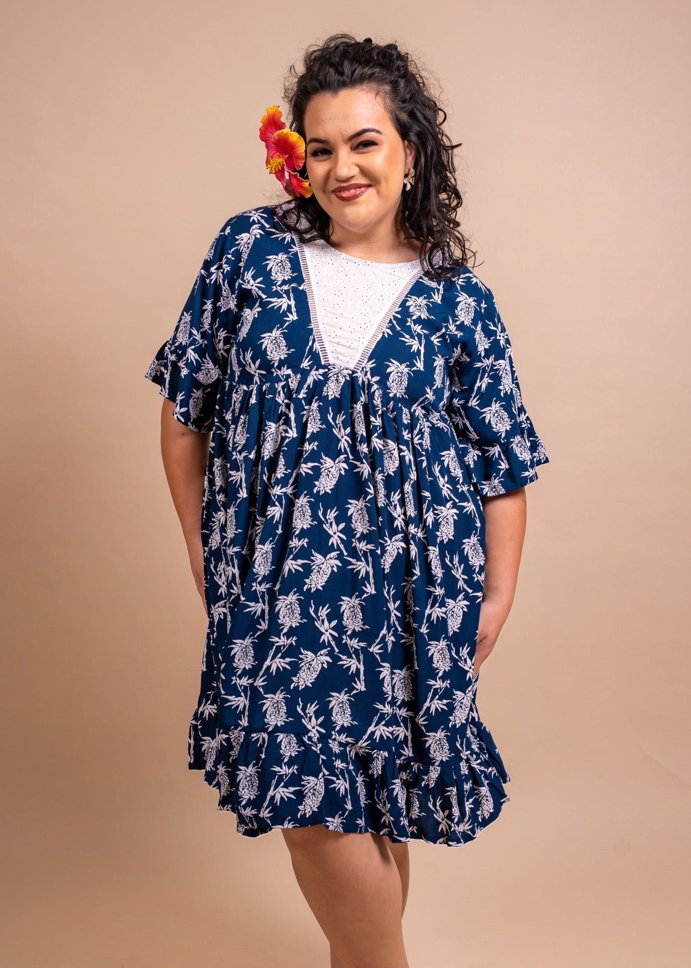 Women wearing a cute polynesian dress in navy blue color with pinaeple pattern