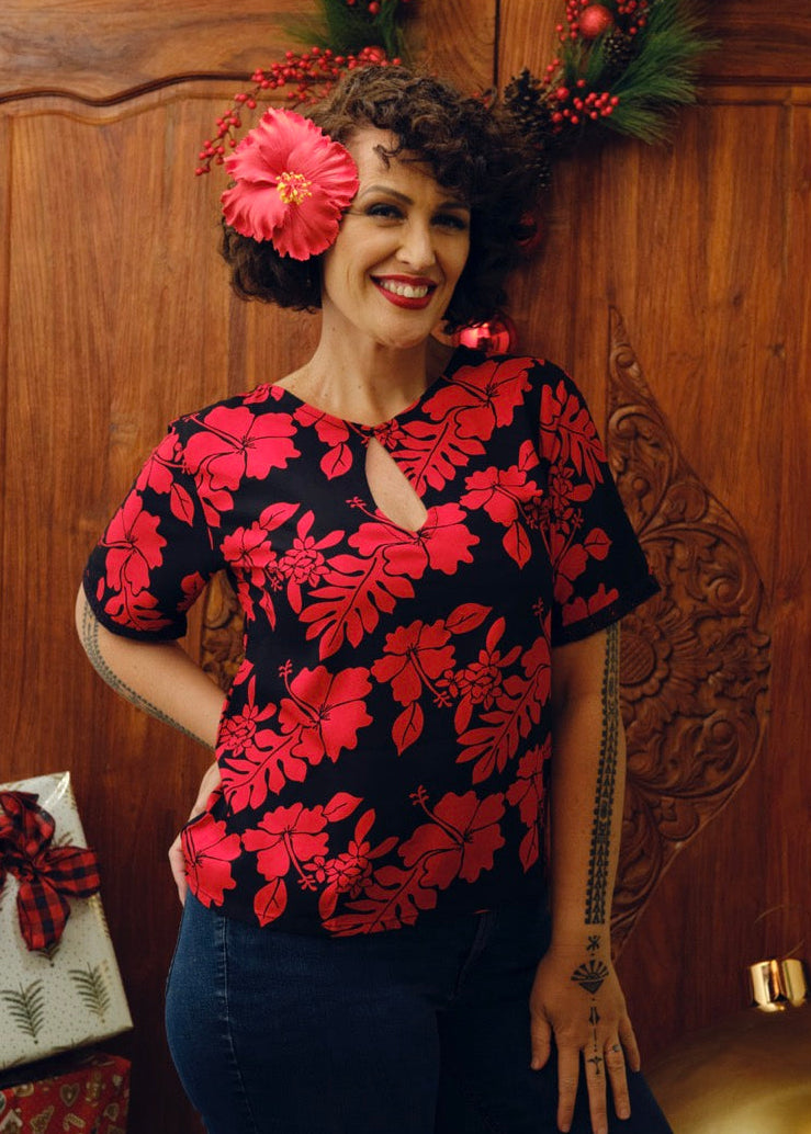 Eimeo Wearing the Maia Shirt in red and Black hibiscus patterns