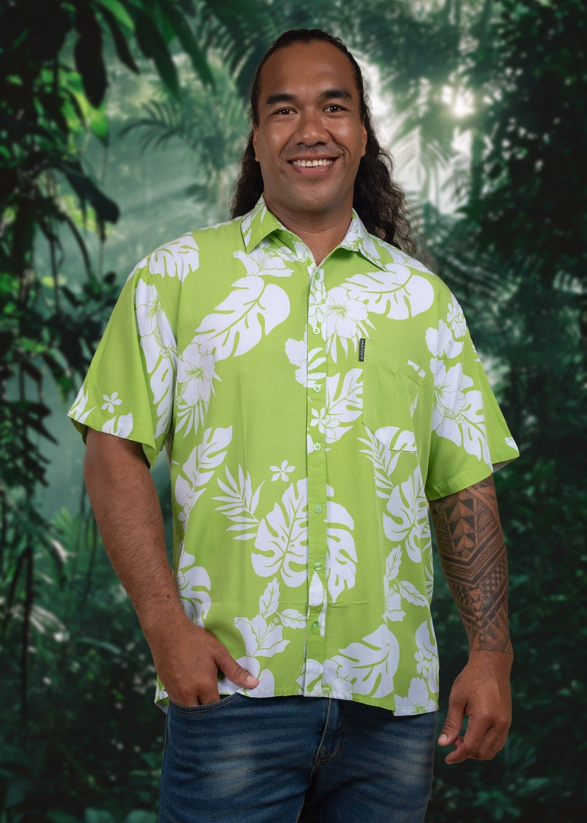 Tattooed Tahitian man wearing a green Polynesian floral Bamboo Kultur shirt.