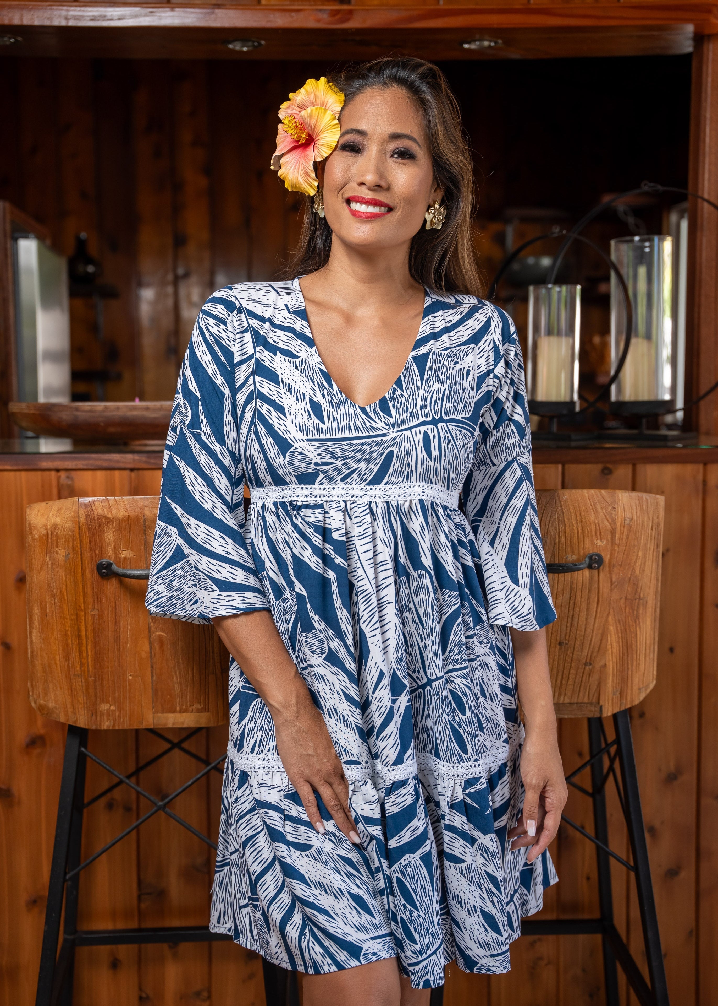 Woman wearing Bamboo Kultur’s “Merahi” short version bleu and white tropical leaf  Polynesian dress