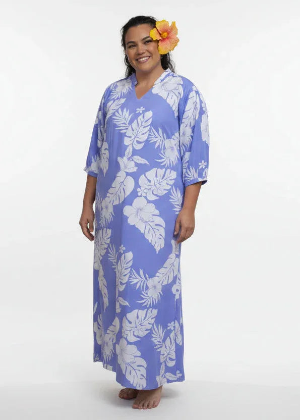 Woman wearing Bamboo Kultur’s Mihivai model lanvender Polynesian floral pattern, in a tropical setting.
