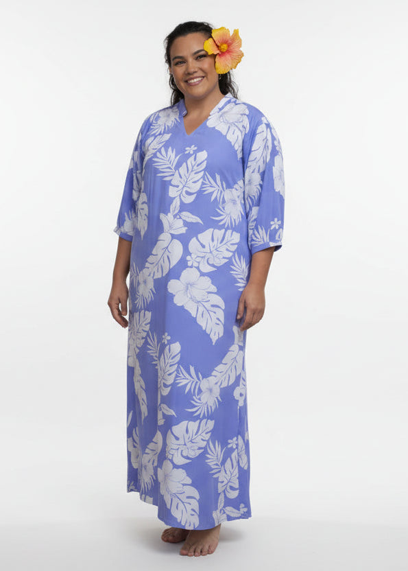 Woman wearing Bamboo Kultur’s Mihivai model lanvender Polynesian floral pattern, in a tropical setting.