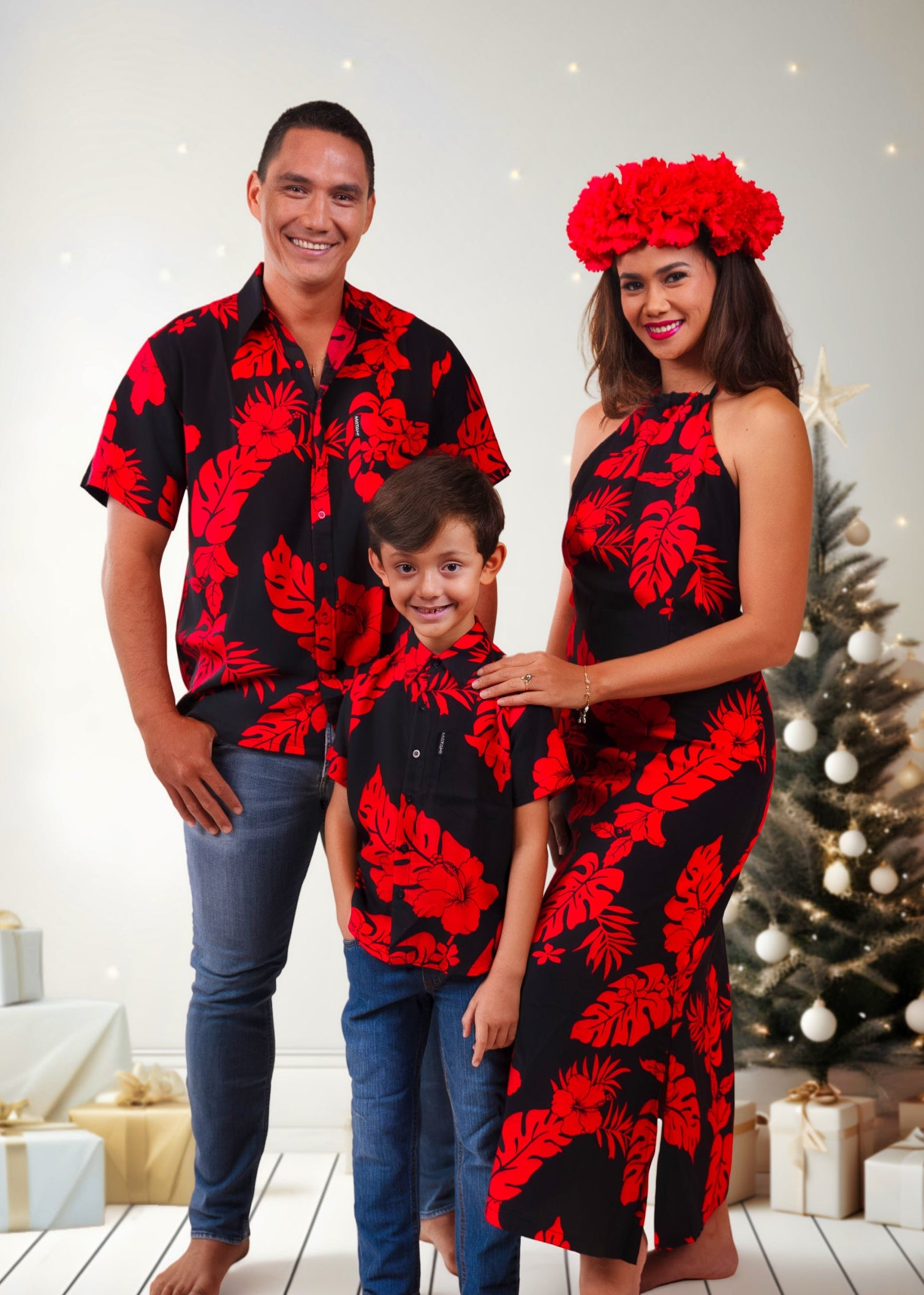 A family wearing the same patterm bamboo kultur clothes. The man and the boys with a nice tropical shirt and the woman with a tropical dress