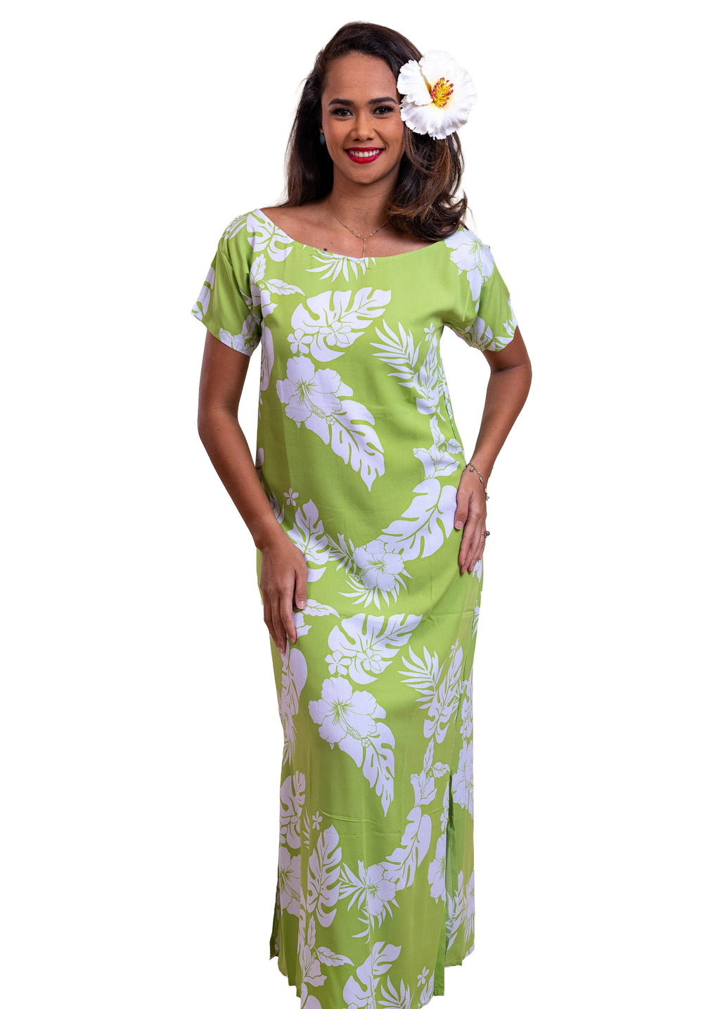 Women with a beautiful white hibiscus on her ear wearing a long polynesian dress in green apple color with hibiscus pattern
