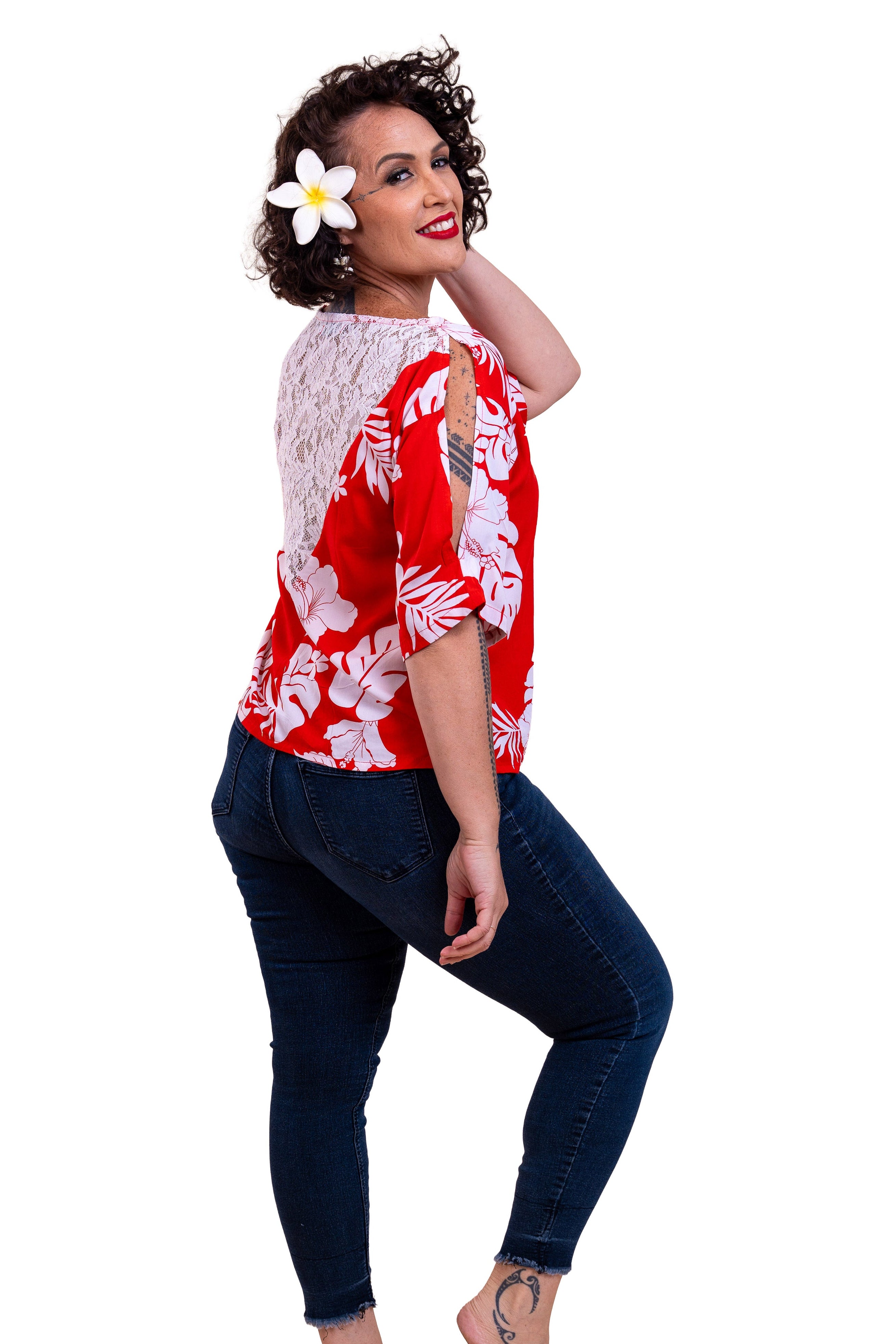 Eimeo Wearing the Teavei Shirt in red and white hibiscus patterns