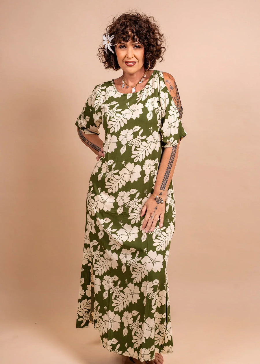 Women with a beautiful tiare tahiti on her ear wearing beautiful polynesian dress in green olive color with hibiscus pattern