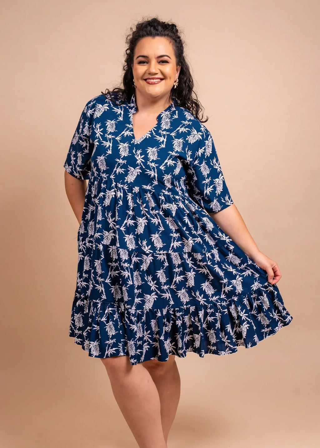 Women wearing a cute polynesian  short dress in navy blue color with pinaeple pattern