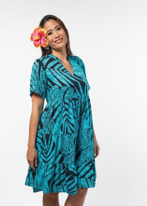 Women wearing Bamboo Kultur’s “Vaihere” blue tropical leaf Polynesian dress in a short version